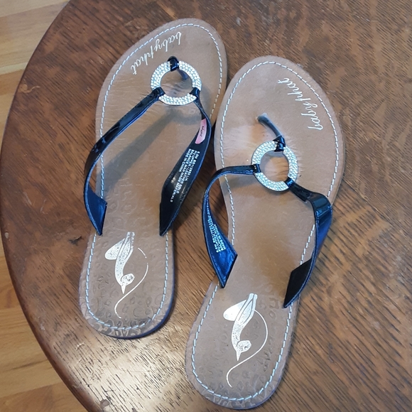 Ladies lightly worn flip flops by baby phat